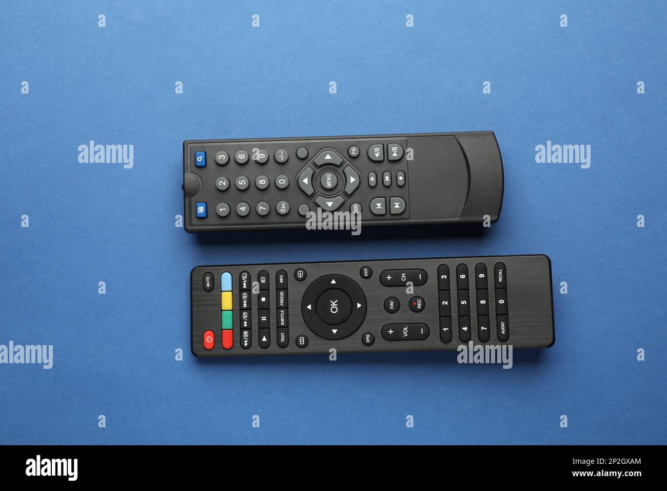 Different remote controls on blue background, flat lay Stock Photo