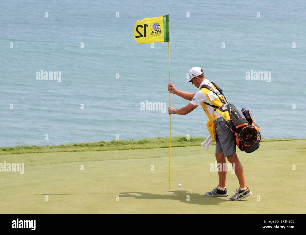 August 16, 2015 Rickie Fowler's caddie removes the pin on number