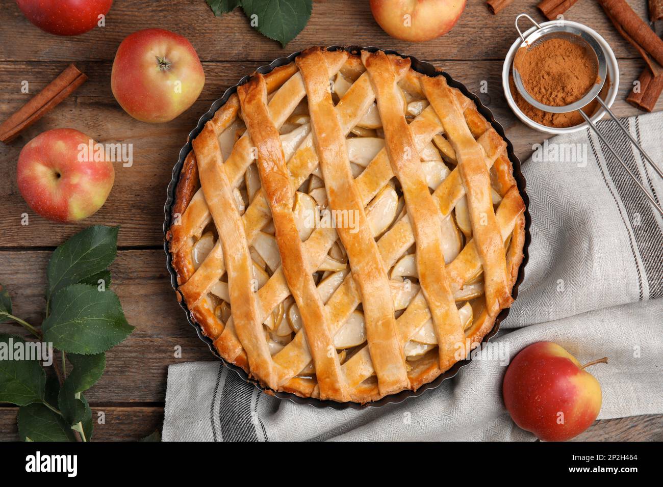 Delicious traditional apple pie on wooden table, flat lay Stock Photo