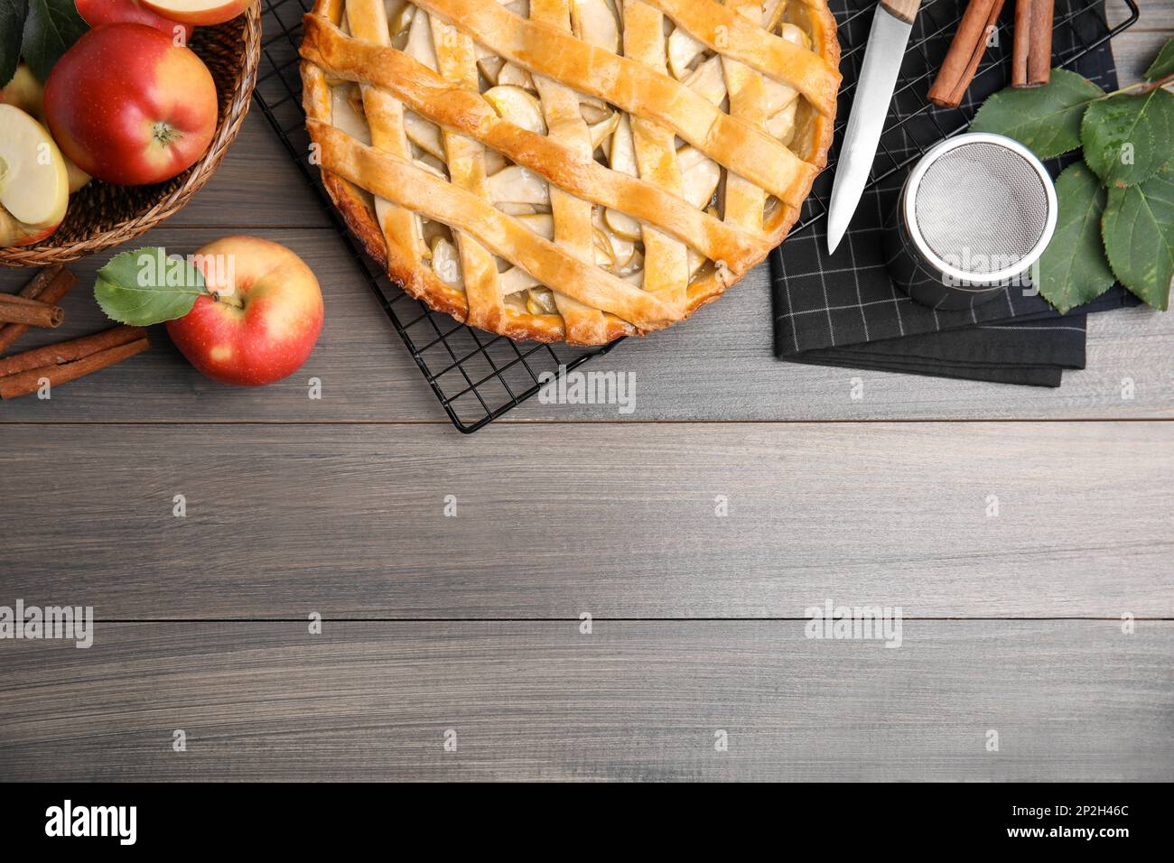Delicious traditional apple pie on wooden table, flat lay. Space for text Stock Photo