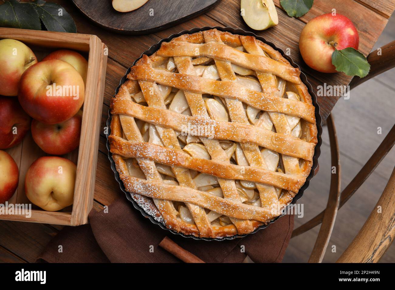 Delicious traditional apple pie on wooden table, flat lay Stock Photo