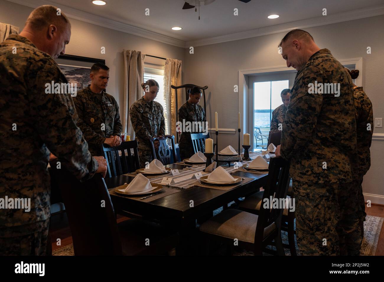 U.S. Marines and Sailors with 2nd Marine Logistics Group pray before