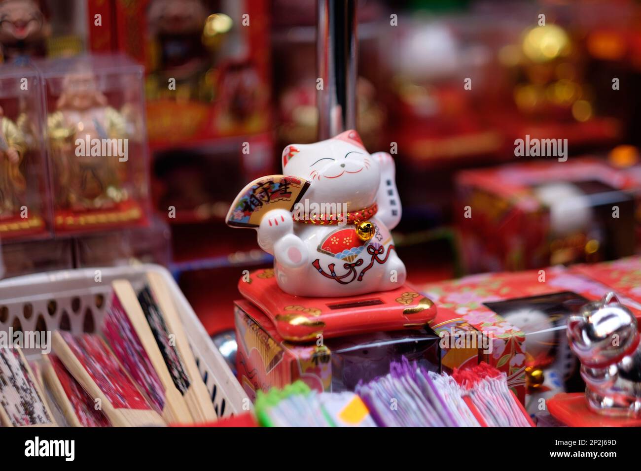 Lucky cat in Chinatown showcase, London Stock Photo