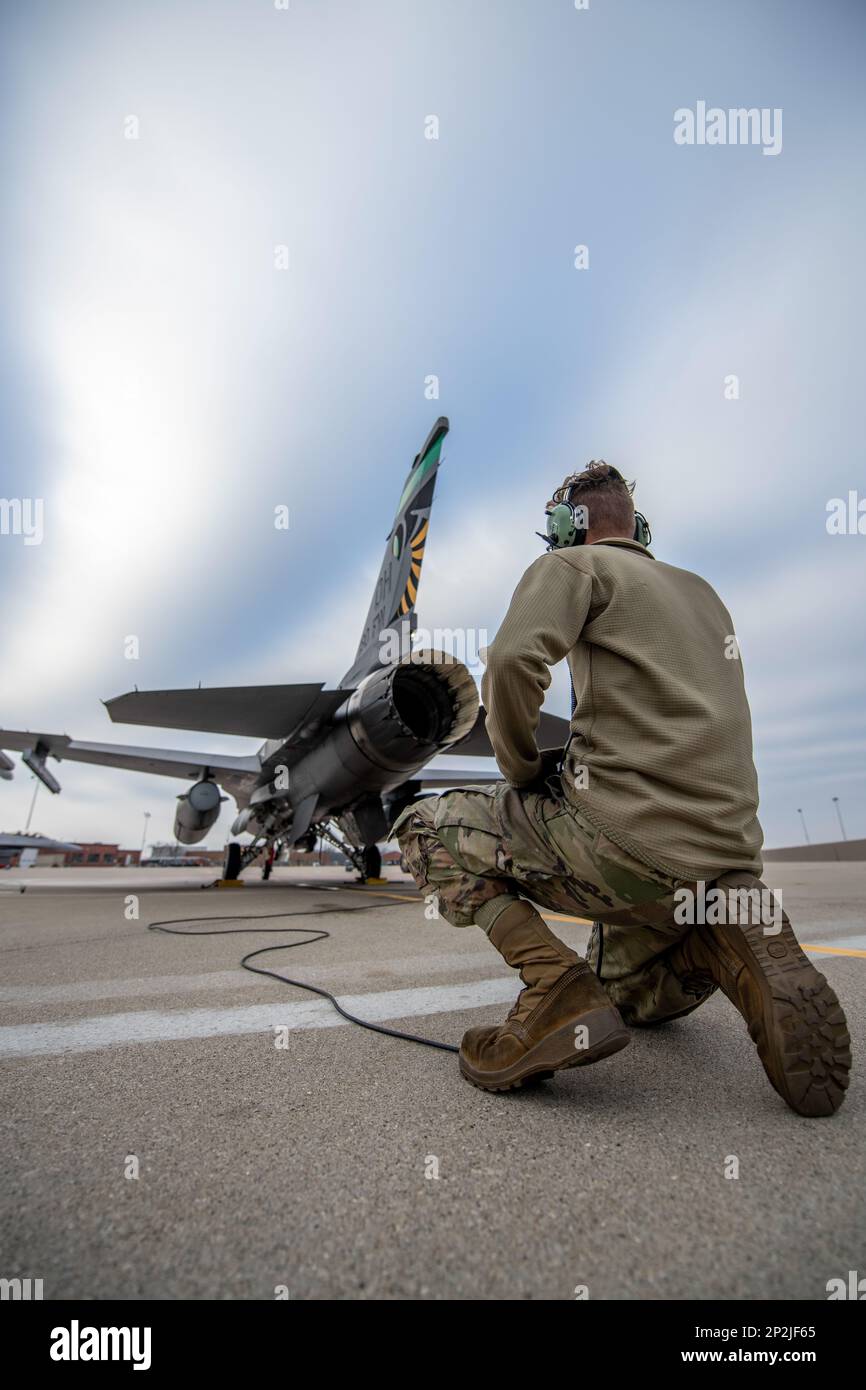 U.S. Air Force Airman 1st Class Riley Metz, an F-16 crew chief assigned to the Ohio National Guard’s 180th Fighter Wing, conducts pre-flight checks on an F-16 Fighting Falcon, assigned to the 180FW, before a training flight at the 180FW in Swanton, Ohio, Jan. 8, 2023. The 180FW is the only F-16 fighter wing in the state of Ohio, whose mission is to provide for America; protection of the homeland, effective combat power and defense support to civil authorities, while developing Airmen, supporting their families and serving in our community. Stock Photo