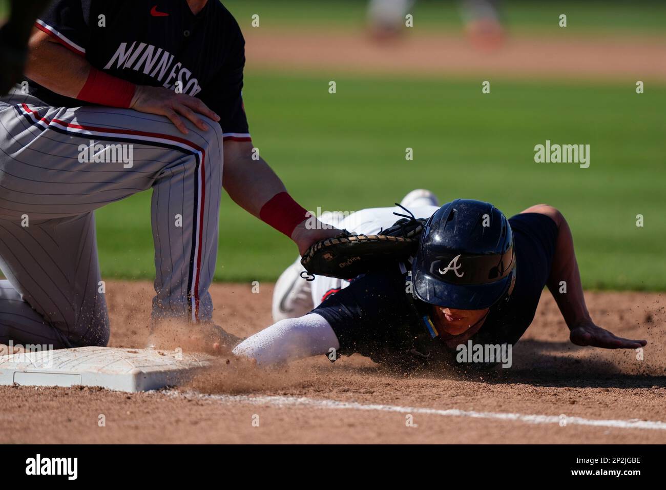 Atlanta Braves' Cade Bunnell avoids the tag by Minnesota Twins first