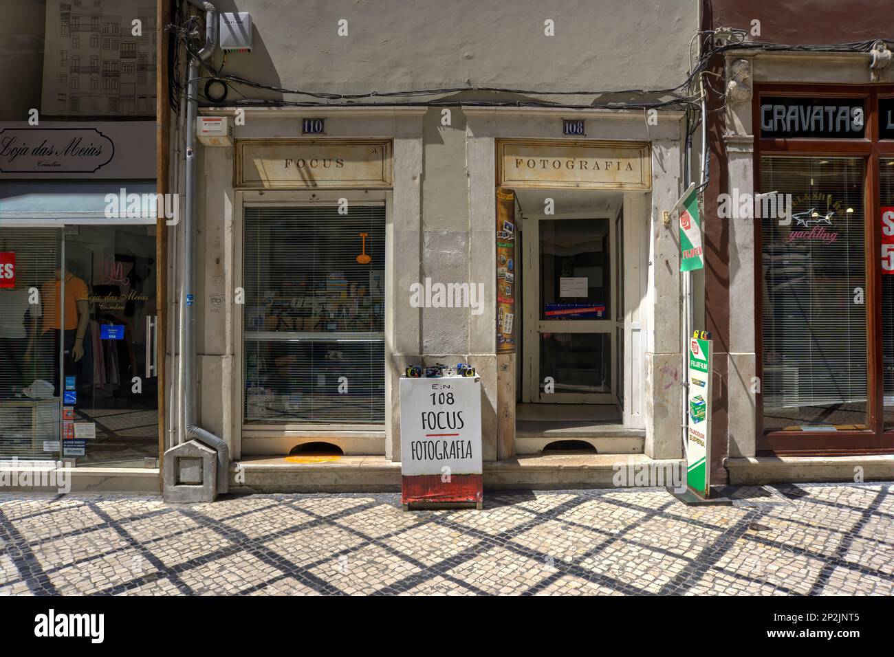 Coimbra, Portugal - August 15, 2022: Frontage of old photographic shop with tiled pavement in foreground Stock Photo