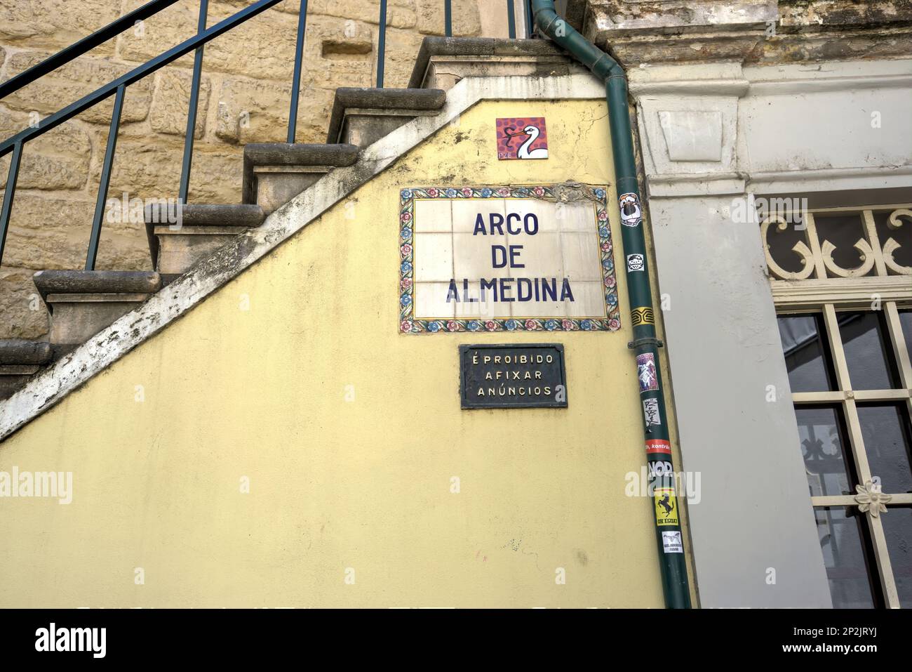 Coimbra, Portugal - August 15, 2022: Tiled street signage Arco De Almedina below staircase Stock Photo