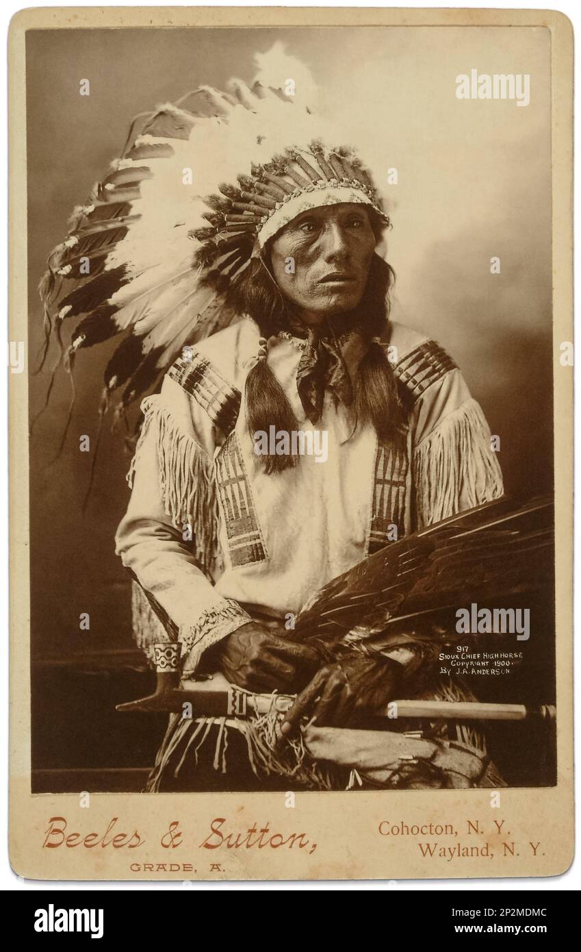 Studio portrait of Sioux Chief High Horse (1852-1931) in 1900 with a golden eagle wing tip fan and a black stone lead inlaid pipe. (Photo by John A. Anderson) Stock Photo