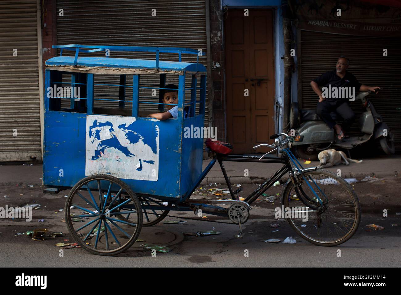 An Indian child on his way to school sits inside a custom-made cycle ...