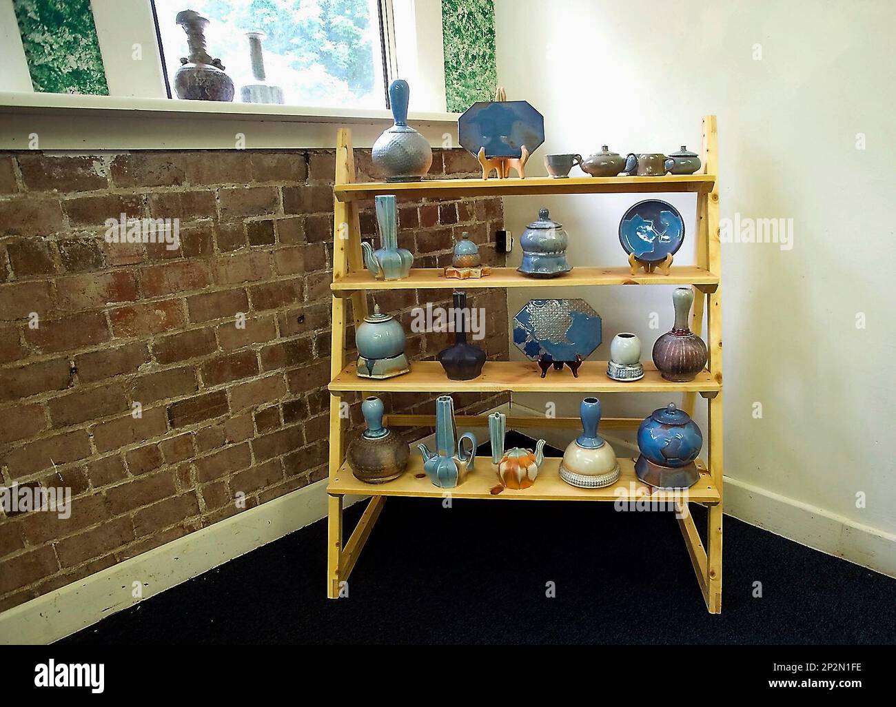In this June 2, 2015 photo, ceramics made by Stephen Grimmer are seen in a  display room at Alto Clay Works in Alto Pass, Ill. Grimmer operates and  lives in the ceramic