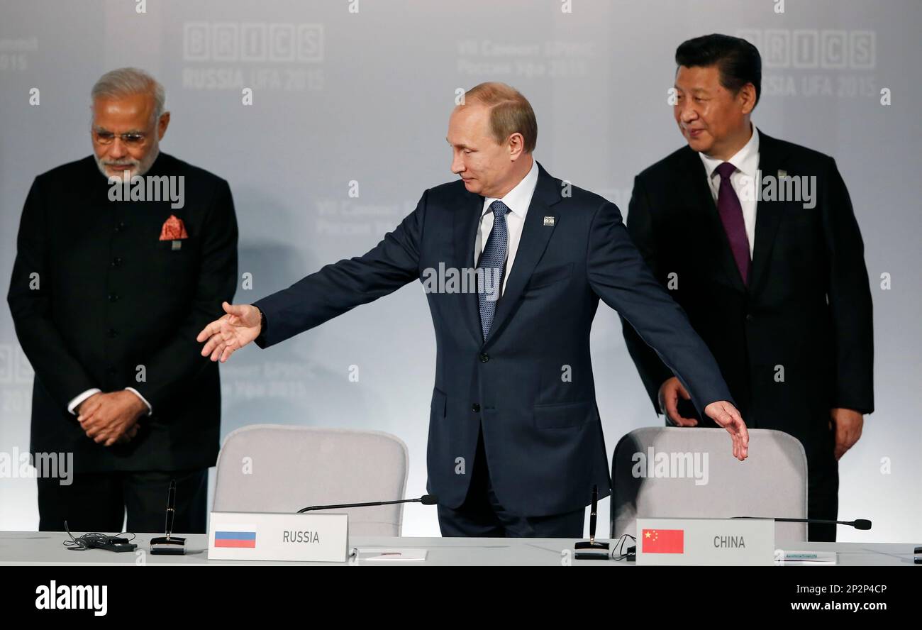 Russian President Vladimir Putin, center, welcomes Indian Prime Minister Narendra Modi, left, and Chinese President Xi Jinping prior signing ceremony at the BRICS Summit in Ufa, Russia, Thursday, July 9, 2015. Ufa is hosting BRICS (Brazil, Russia, India, China and South Africa) and SCO (Shanghai Cooperation Organisation) summits. (Sergei Ilnitsky/Pool photo via AP) Stock Photo