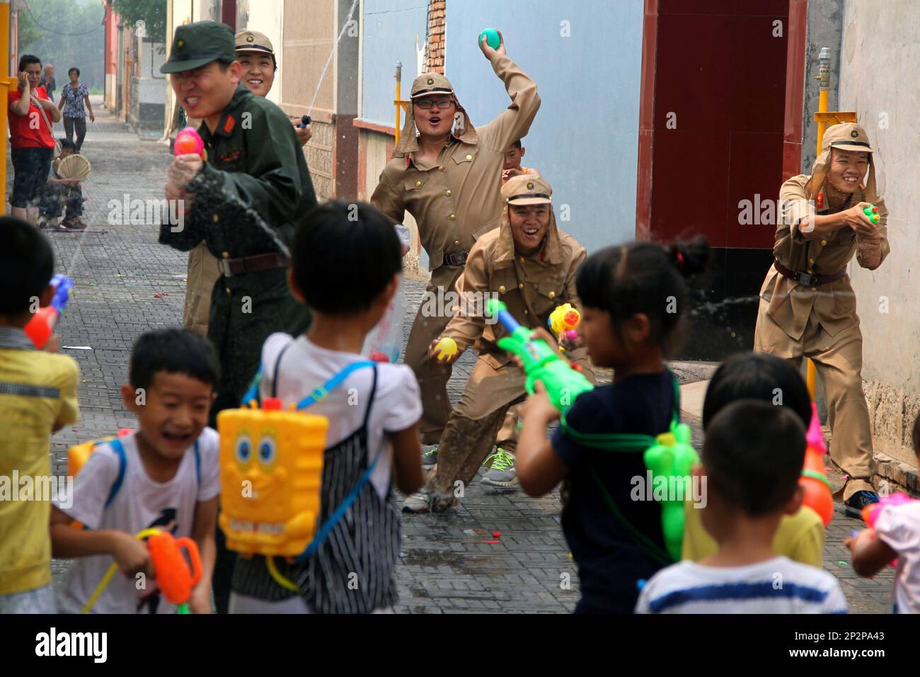 Chinese man frightened by two toy figures of Japanese soldiers and a turtle hanging by strings main image 1