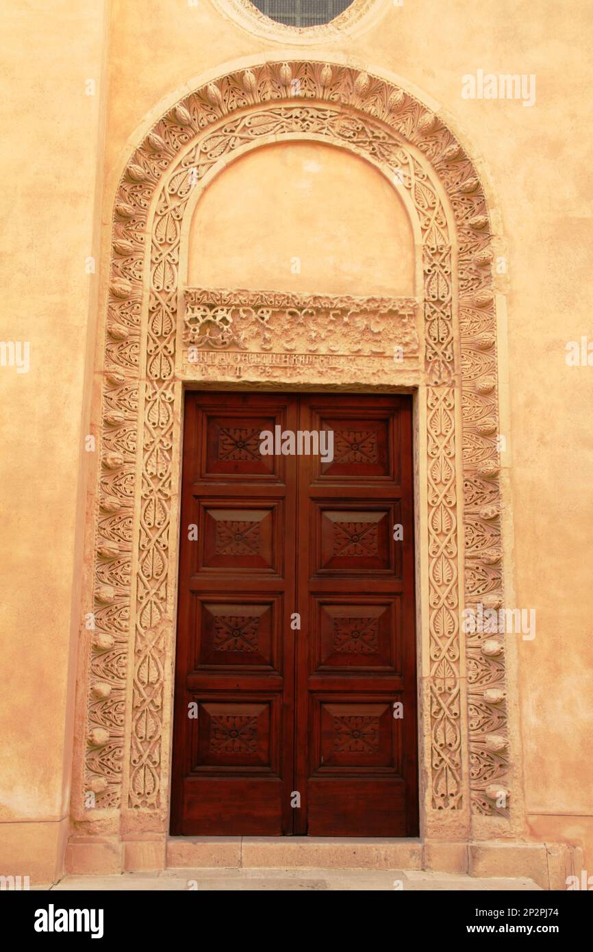 Galatina, Italy. Exterior of the 14th century Santa Caterina d'Alessandria Catholic Church. Door with beautiful decorative elements. Stock Photo