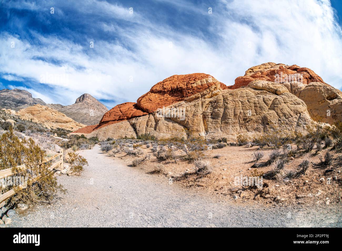Hiking trail leading into the deep heart of Red Rock Canyon in Las Vegas shows a vibrant day to be active and enjoy leisure time. Stock Photo