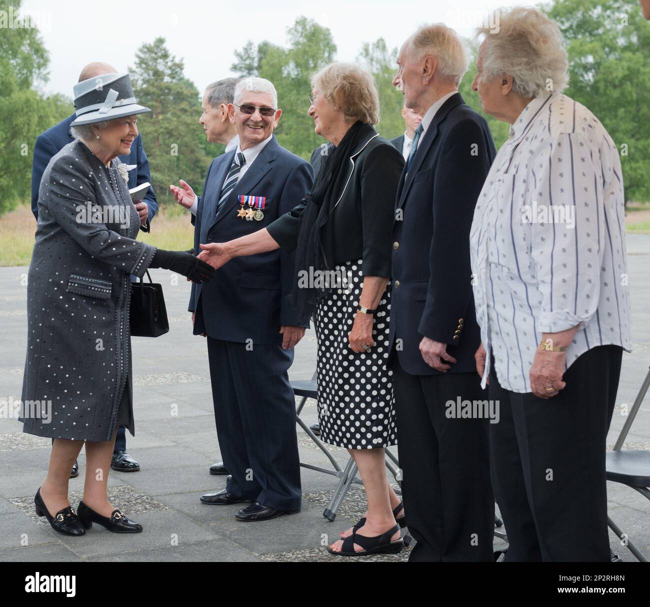 Queen Elizabeth II, left, talks with contemporary witnesses during her ...