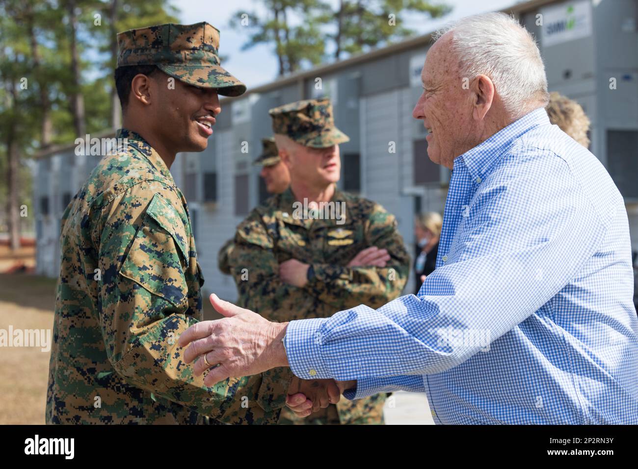 U.S. Navy Hosiptalman Gary Clarke with 2nd Medical Battalion, 2nd Marine Logistics Group, is congratulated by David Brown, a member of the Military Affairs Committee of the Swansboro Area Chamber of Commerce, after awarding him the Swansboro Area Chamber of Commerce Award during a ceremony on Camp Lejeune, North Carolina, Feb. 9, 2023. The Swansboro Area Chamber of Commerce Award aims to recognize outstanding service members for their knowledge, skills, and work ethic. Stock Photo