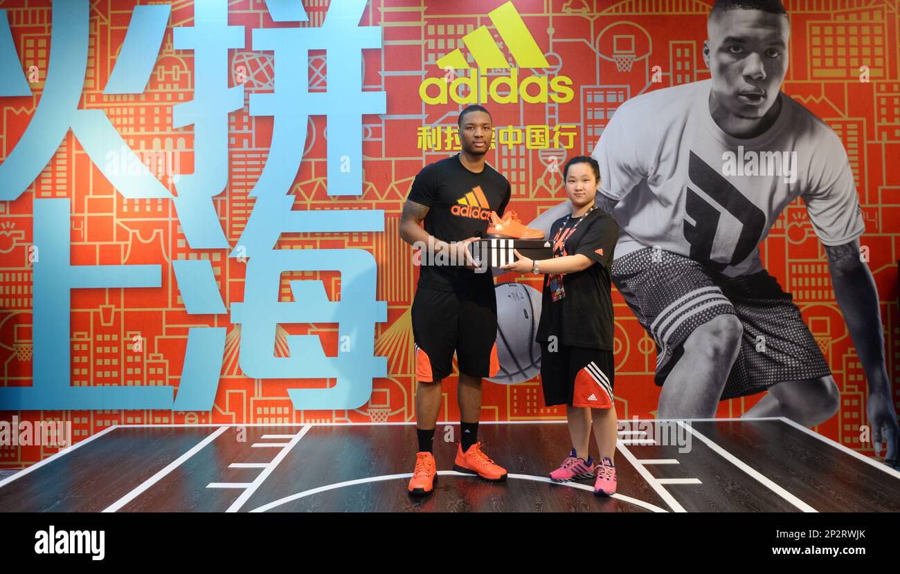 NBA star Damian Lillard left poses with a Chinese fan at a fan meeting event in Shanghai China 22 June 2015. Imaginechina via AP Images Stock Photo Alamy