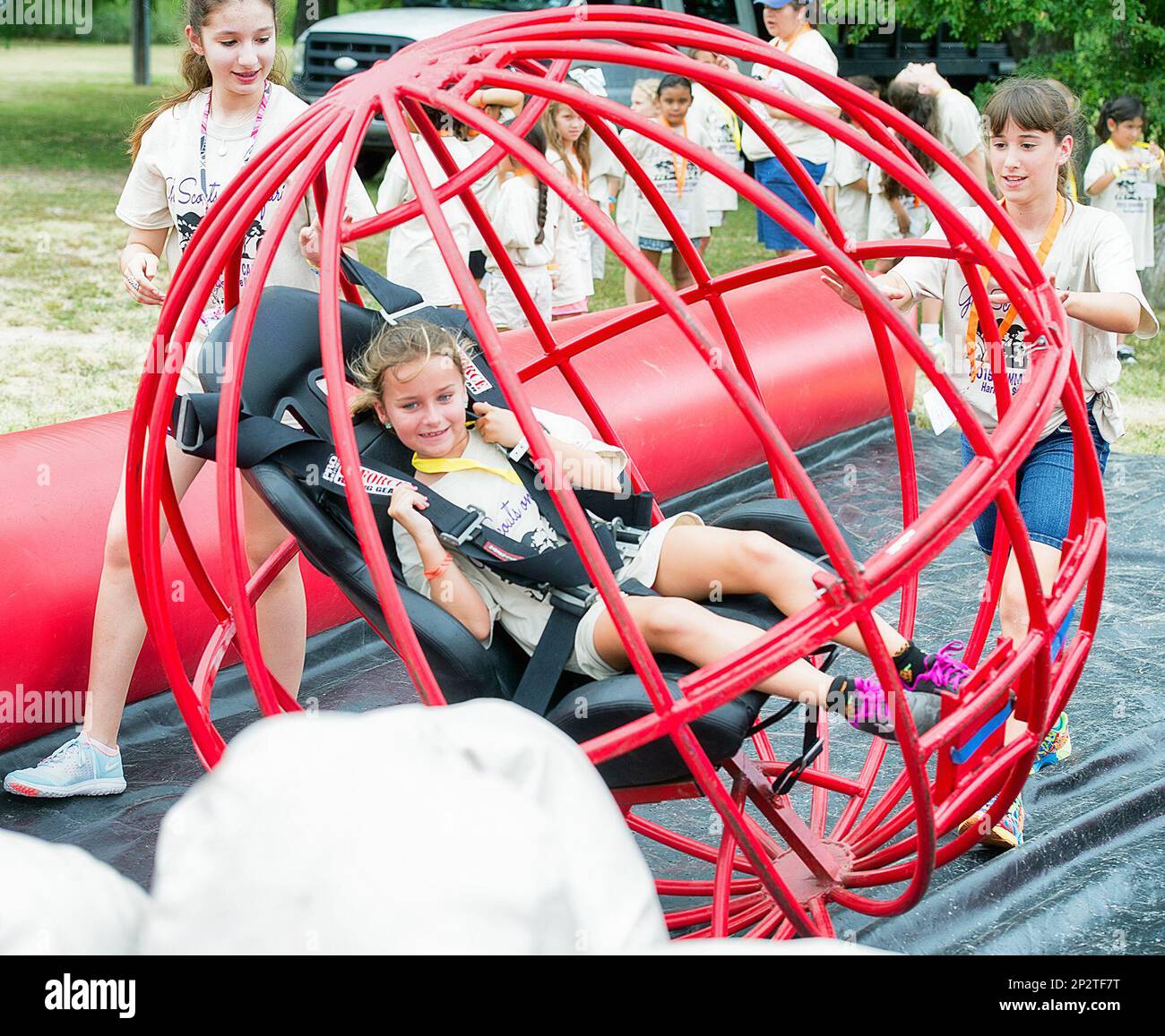 Girls sit inside the human bowling ball while knocking pins down at girl  scout summer camp on Monday, June 15, 2015 in Harlingen, Texas. (David  Pike/Valley Morning Star via AP Stock Photo -