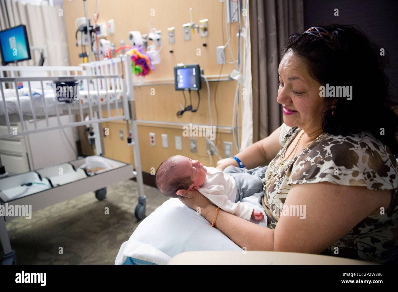 In this Friday, June 5, 2015 photo, Berta Jimenez holds her grandson, Angel,  2 months in the NICU at Methodist Women's Hospital in Omaha, Neb. Angel  Perez, the infant son born of