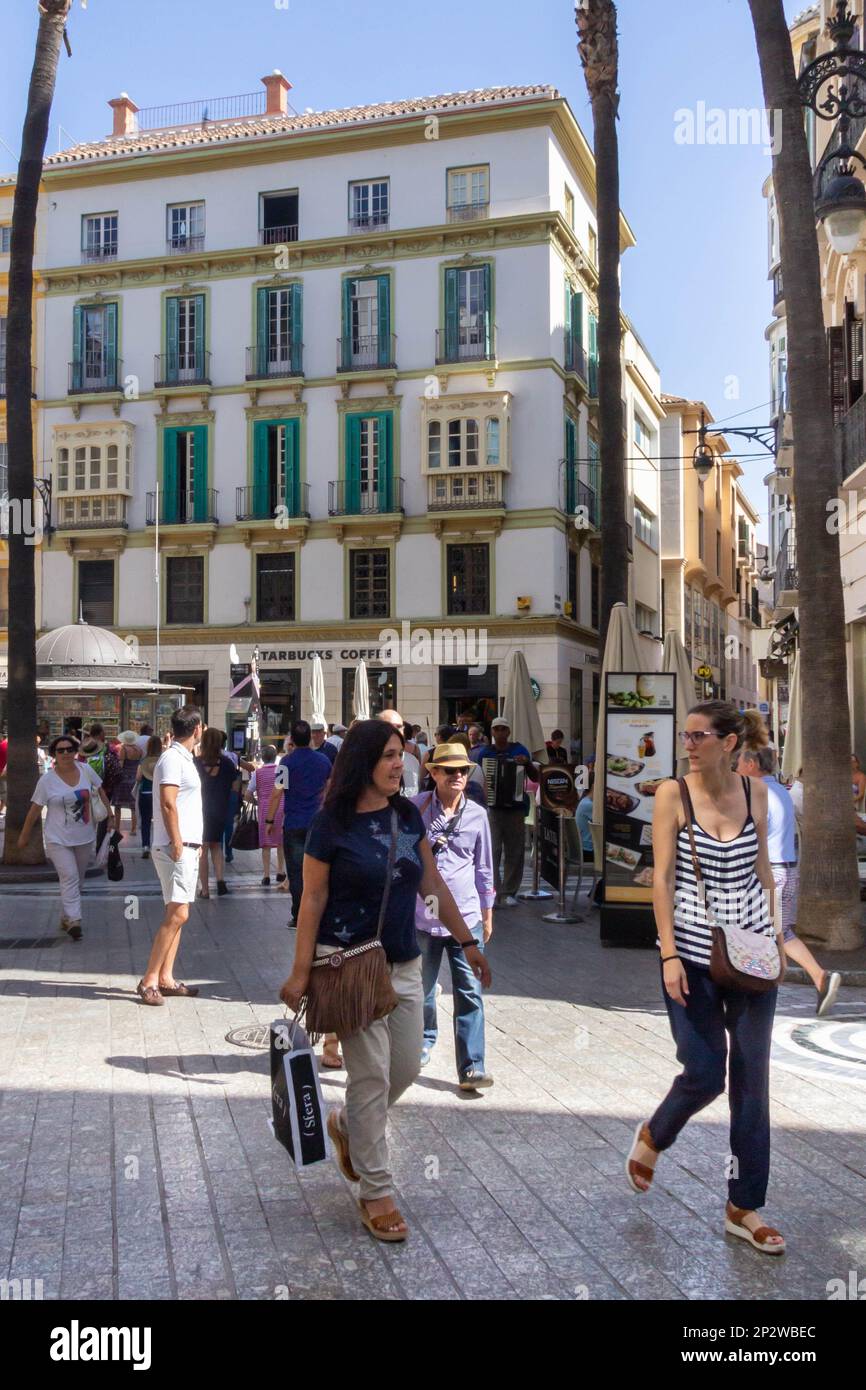 Malaga, Spain - June 18th 2018: Shoppers and tourists on a street in Malaga. The city is the capital of a province with the same name Stock Photo