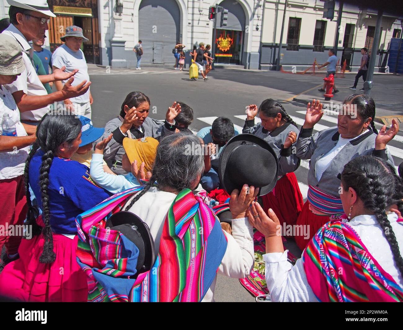 A group of indigenous women carry out a healing ritual in the downtown of  Lima, at the exact point where one of them was injured the day before by a  tear gas