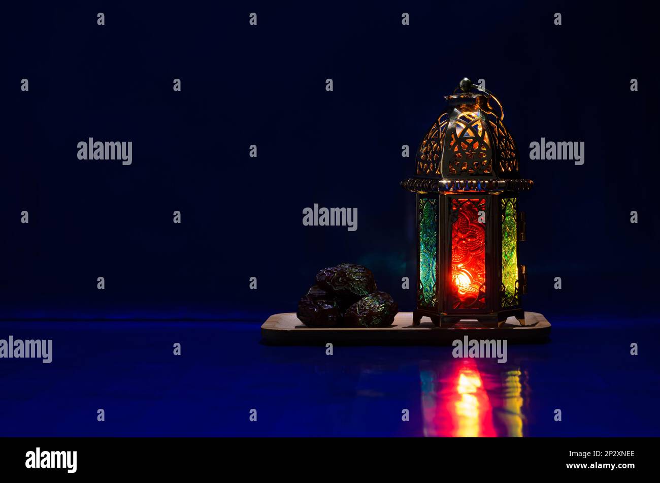 Lantern and dates fruit put on table with dark blue background for the ...