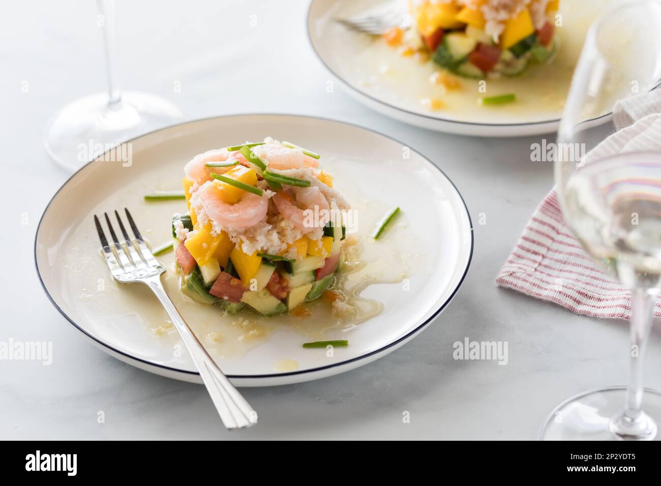 Crab and shrimp stack salad made with mango, cucumber and avocado Stock ...