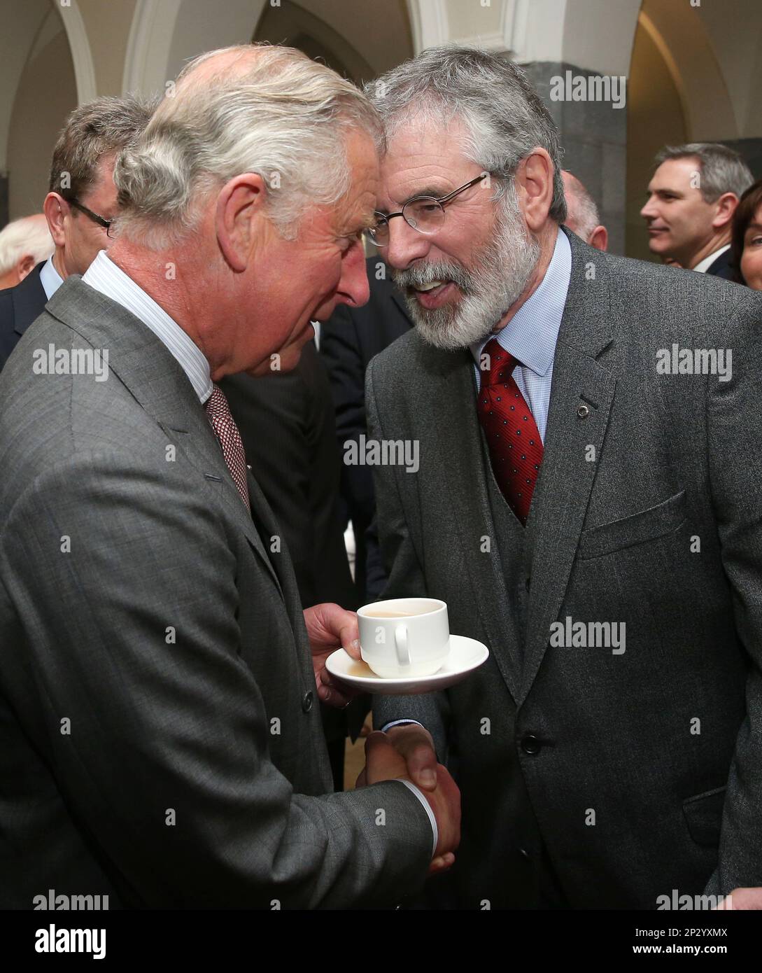 Britain's Prince Charles. left, shakes hands with Sinn Fein president