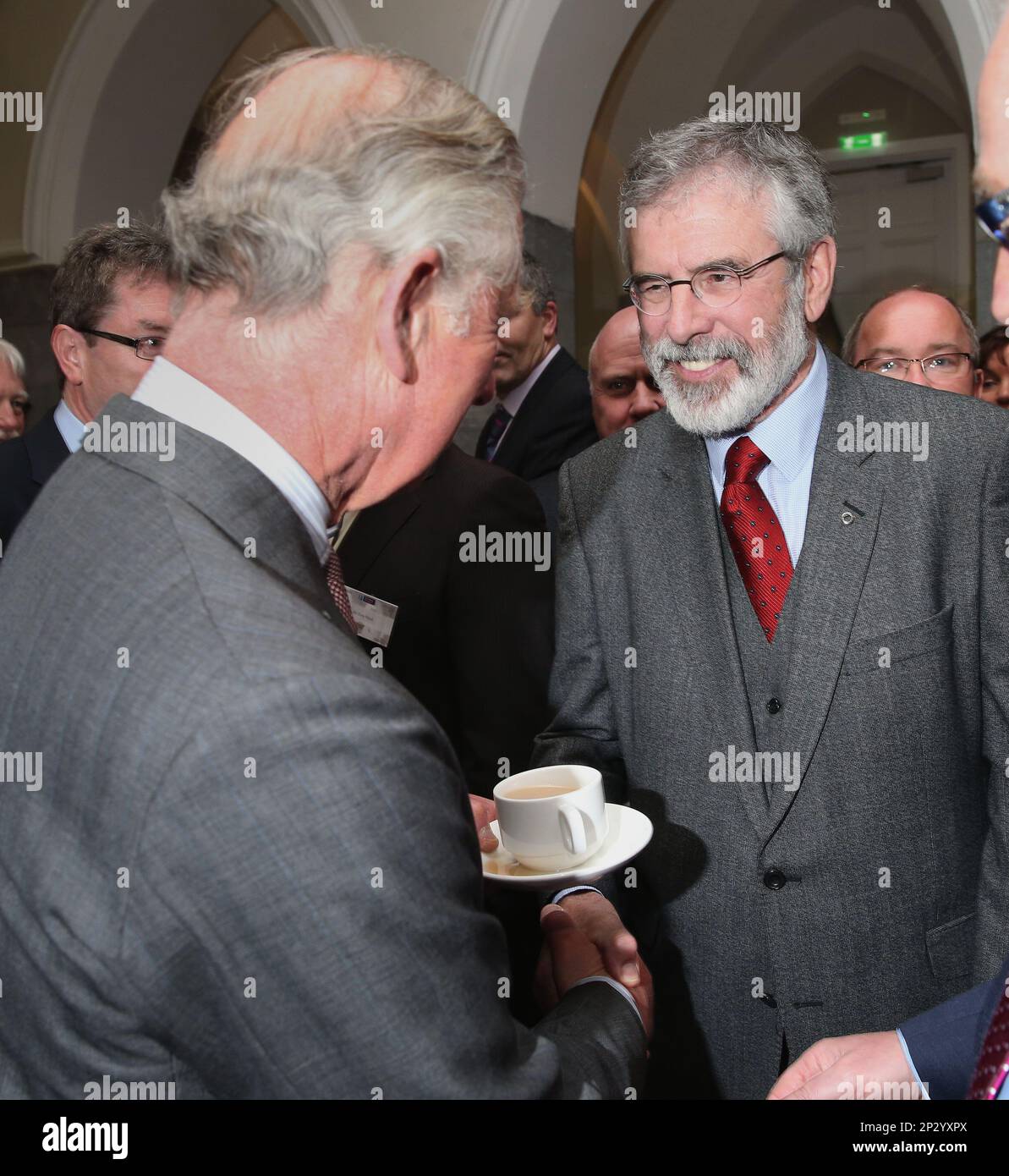 Britain's Prince Charles. left, shakes hands with Sinn Fein president