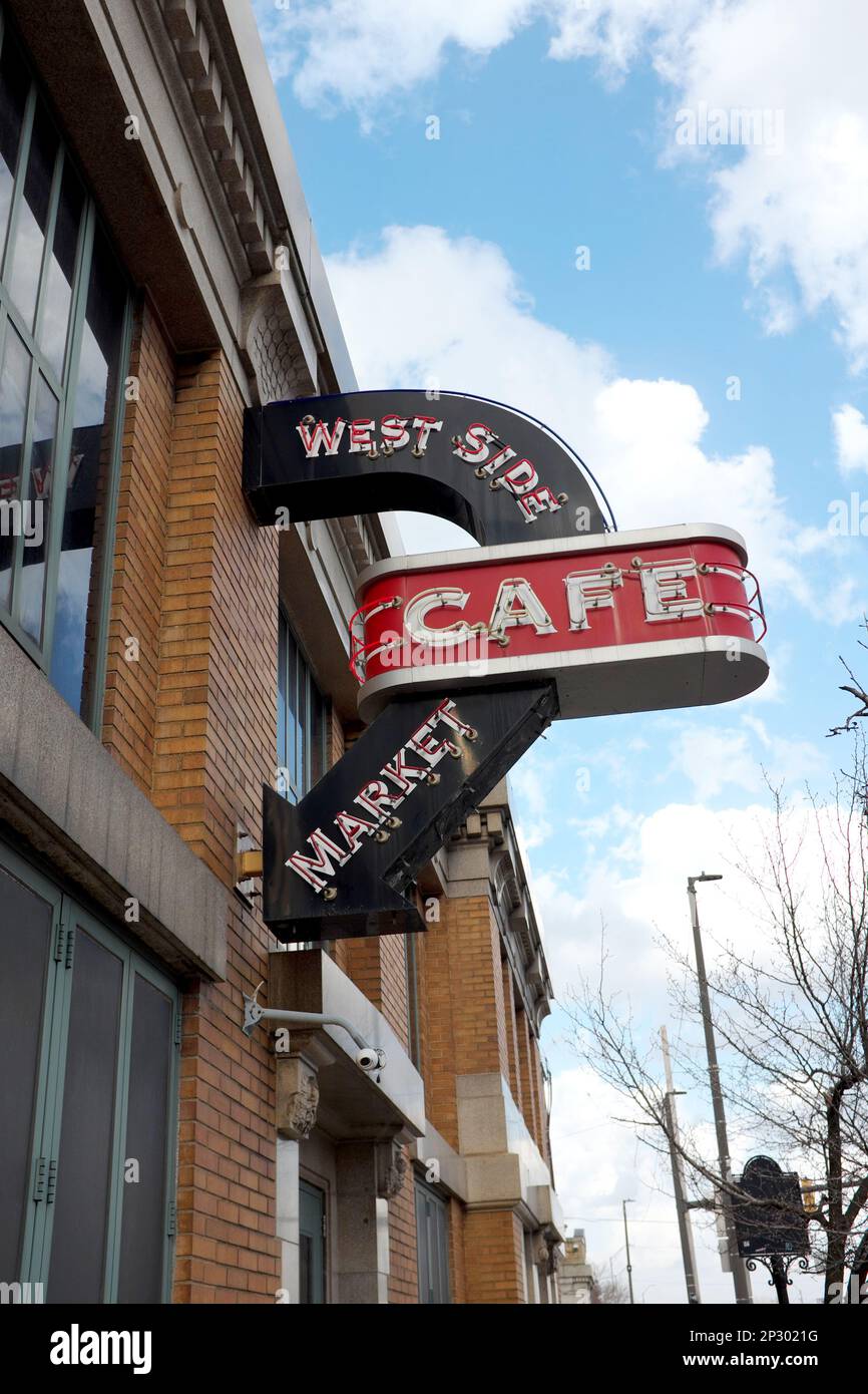 The West Side Market Cafe neon sign pointing to the indoor cafe inside the historic landmark West Side Market on West 25th Street in Cleveland, Ohio. Stock Photo