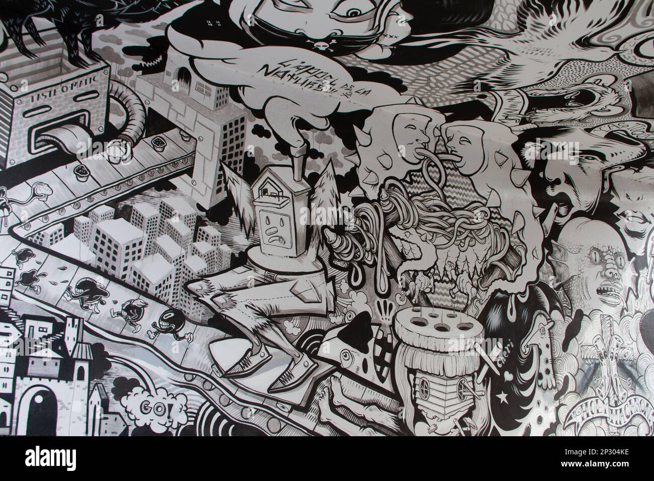 Creative black and white graffiti street art mural lining the street of ...