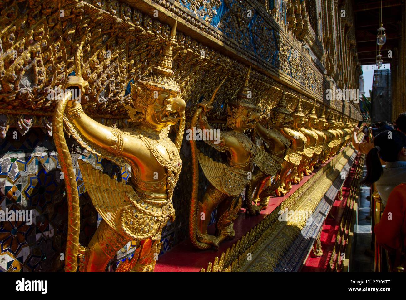 Wat Phra Kaew Grand Palace Bangkok.Supporting giants around the base.One hundred and twelve Garudas, each grasping within its claws two Naga serpents, Stock Photo