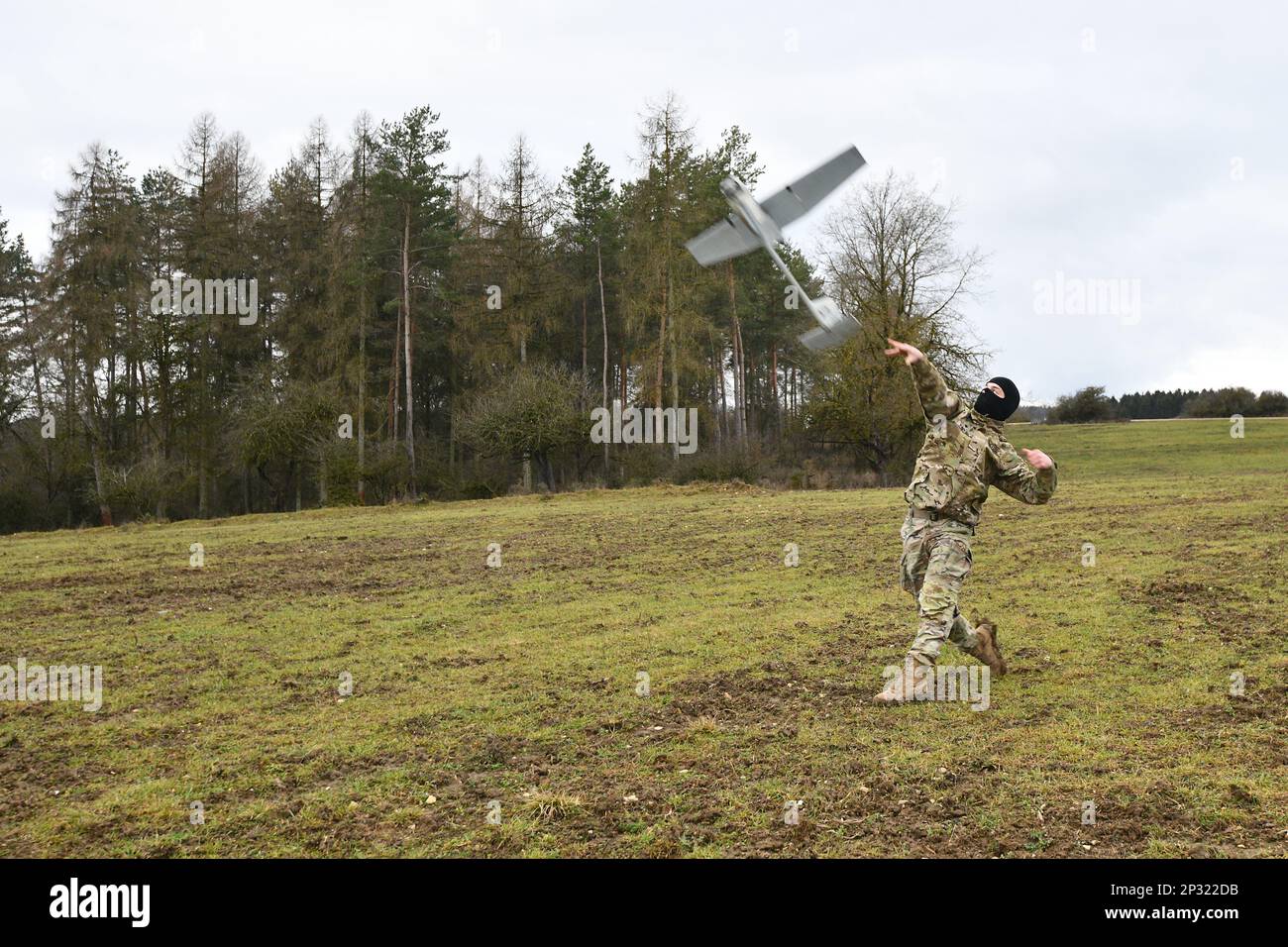 A U.S. Soldier with Palehorse Troop, 4th Squadron, 2nd Cavalry Regiment launches an RQ-11 Raven, a Small Unmanned Aircraft System, at the 7th Army Training Command’s Grafenwoehr Training Area, Germany, Jan. 10, 2023. 2CR provides V Corps with a lethal and agile force capable of rapid deployment throughout the European theater in order to assure allies, deter adversaries, and when ordered, defend the NATO alliance. Stock Photo