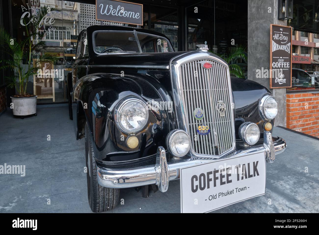 An old, black Rolls Royce placed outside Coffee Talk Cafe in Ratsada Road in the Old Town area of Phuket Town (Phuket City), Phuket, Thailand Stock Photo