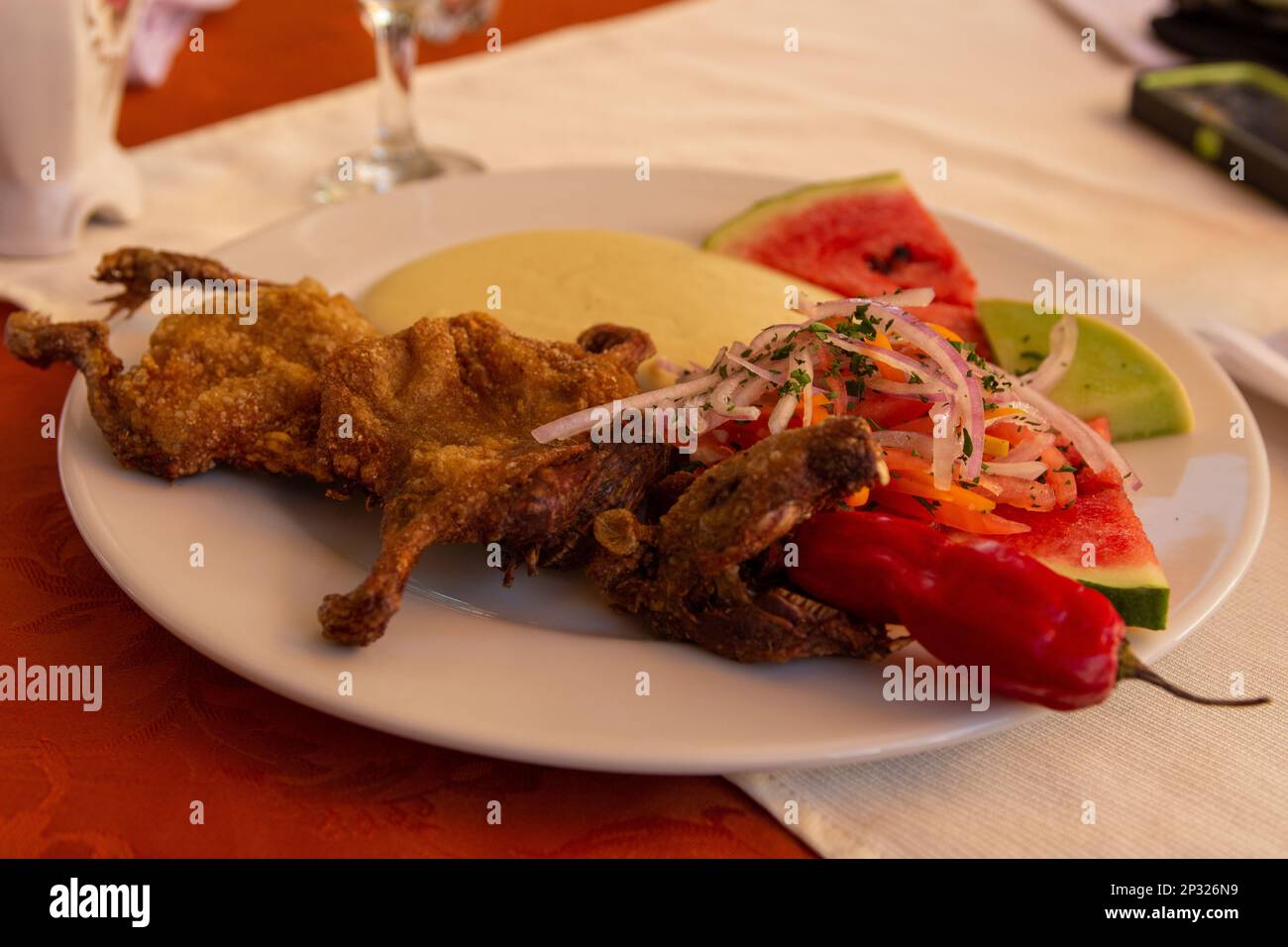 Peruvian Cuy Served on a plate for dinner Stock Photo