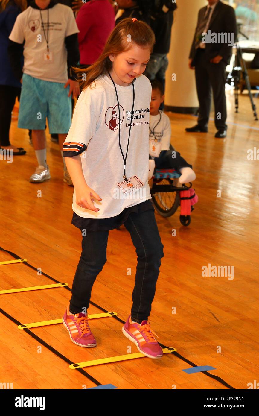 30 APR 2015 Shriners Hospital patient Mackenzie runs the rope ladder
