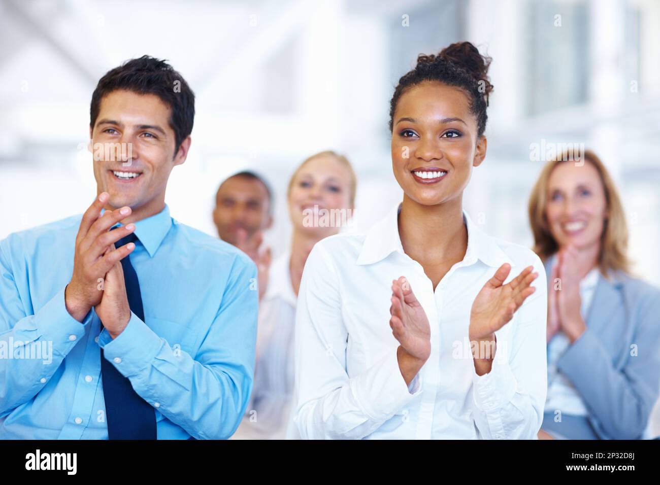 Successful seminar. Portrait of happy multi ethnic business people applauding after successful seminar. Stock Photo