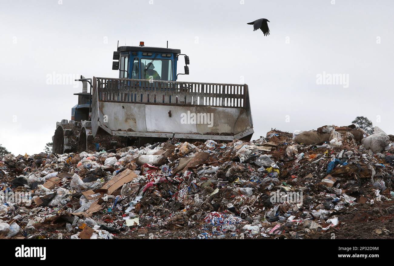 In this Dec. 5, 2015 photo, a bulldozer moves piles of trash at the