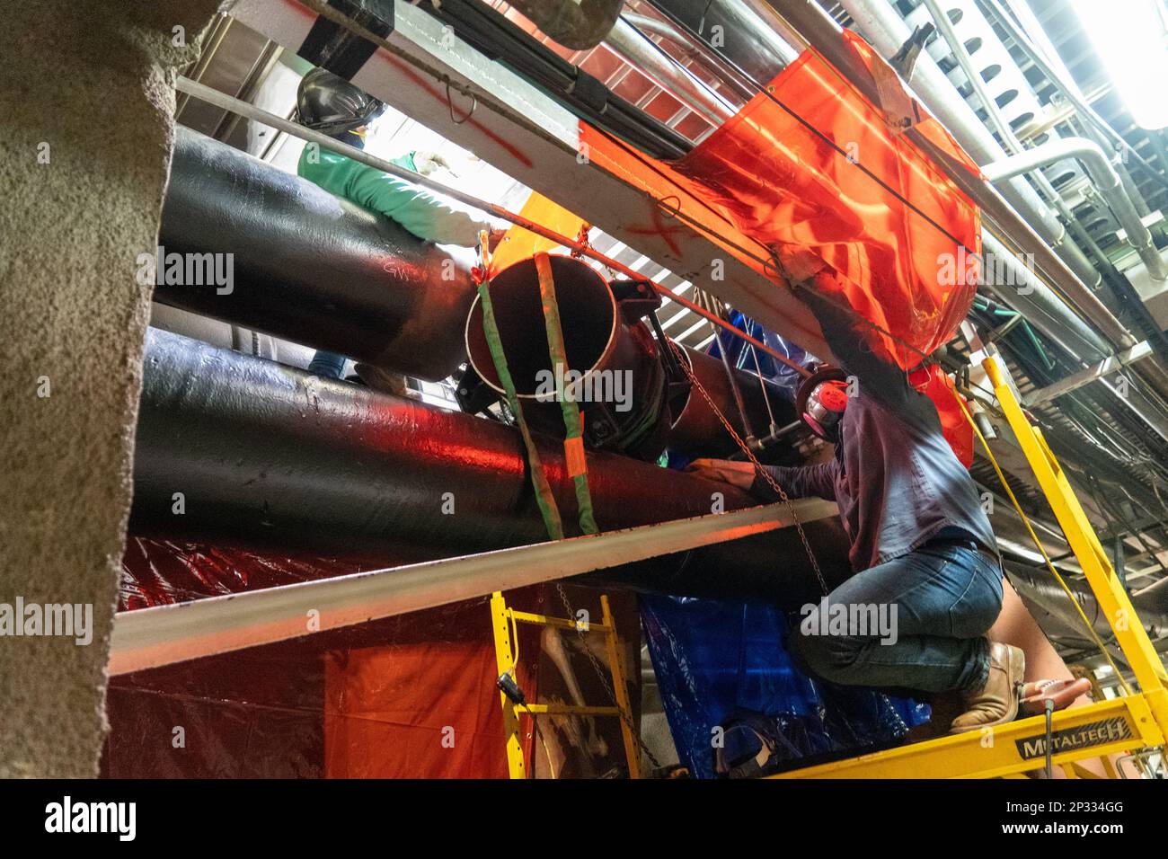 Contractors remove a pipe section during ongoing repairs at the Red