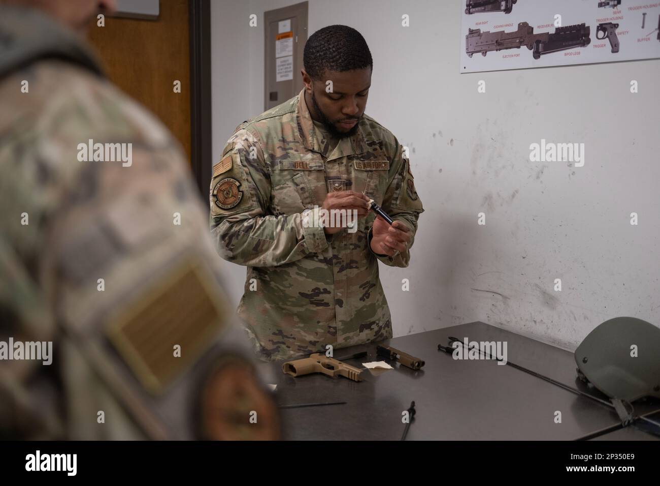 U.S. Air Force Senior Airman Jamarcus Bell, 41st Rescue Generation Squadron weapons journeyman, cleans an M18 Modular Handgun System after a weapons qualification class at Moody Air Force Base, Georgia, Jan. 5, 2022. Standard gun cleaning brushes, a cloth and lubricant are all used to brush away debris so the weapon can function smoothly. The main type of lubrication used to wipe down the weapon is cleaner lubricant preservative. Stock Photo