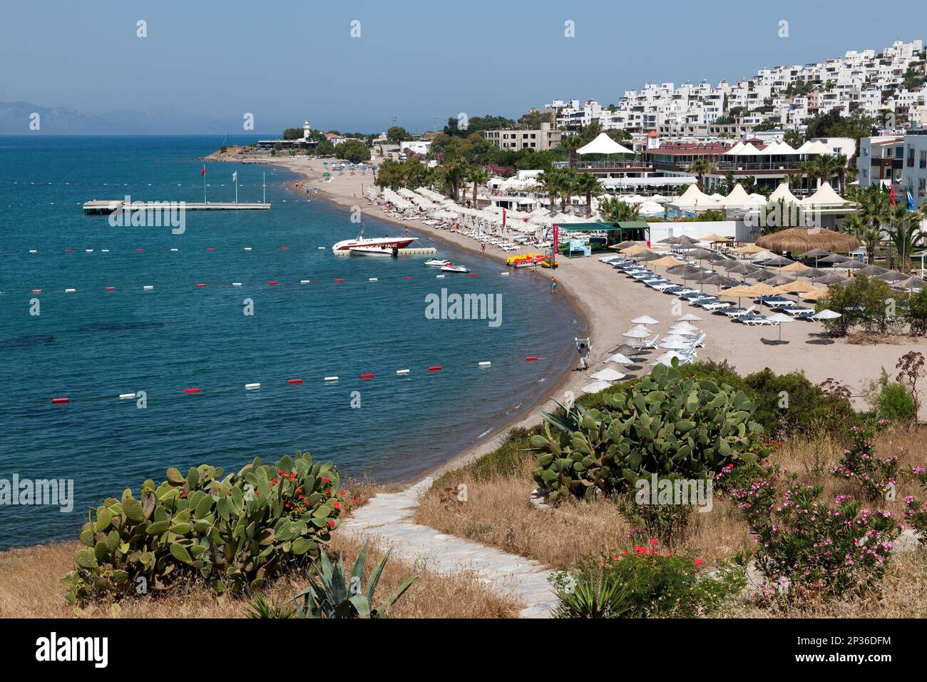 View of beach near Akyarlar, on the right in the picture hotel facilities on the Mediterranean Sea, Akyarlar, Mugla, Turkey Stock Photo
