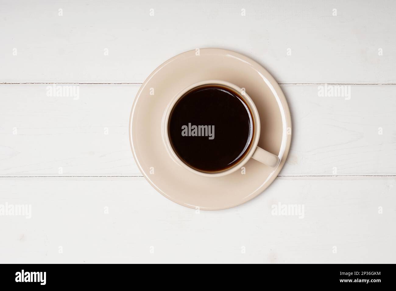 topview of cup of black coffee on white wooden background with copy space Stock Photo