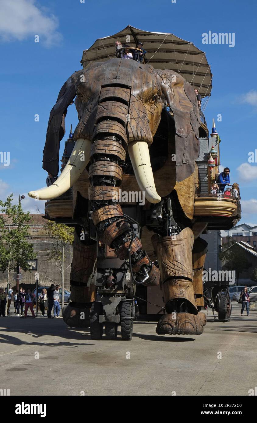 Tourists riding on gigantic mechanical elephant, The Great Elephant, Machines of the Isle of Nantes, Nantes, Loire-Atlantique, Pays de la Loire Stock Photo