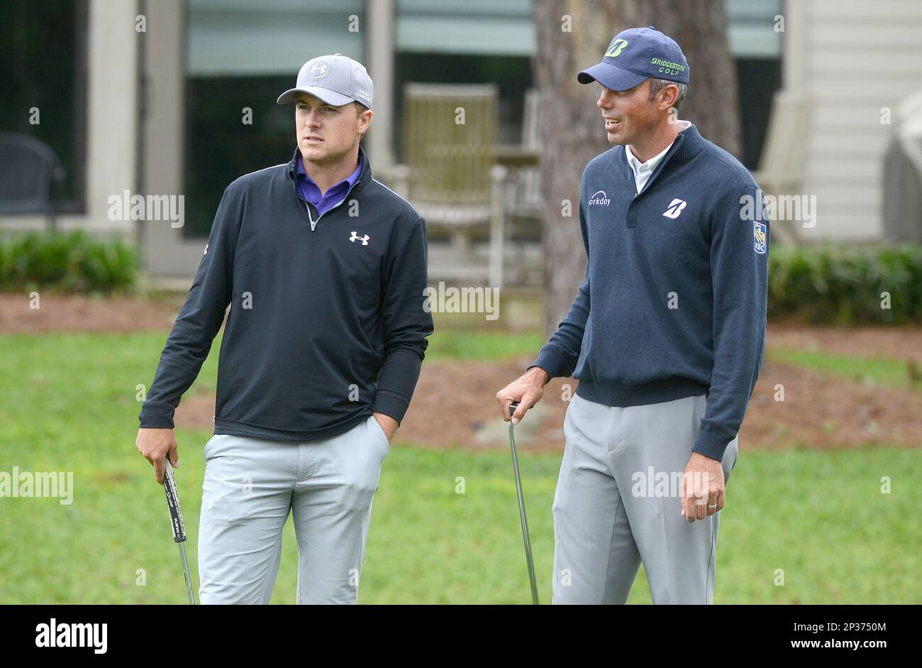 Jordan Spieth, left, and Matt Kuchar watch as Patrick Reed hits his