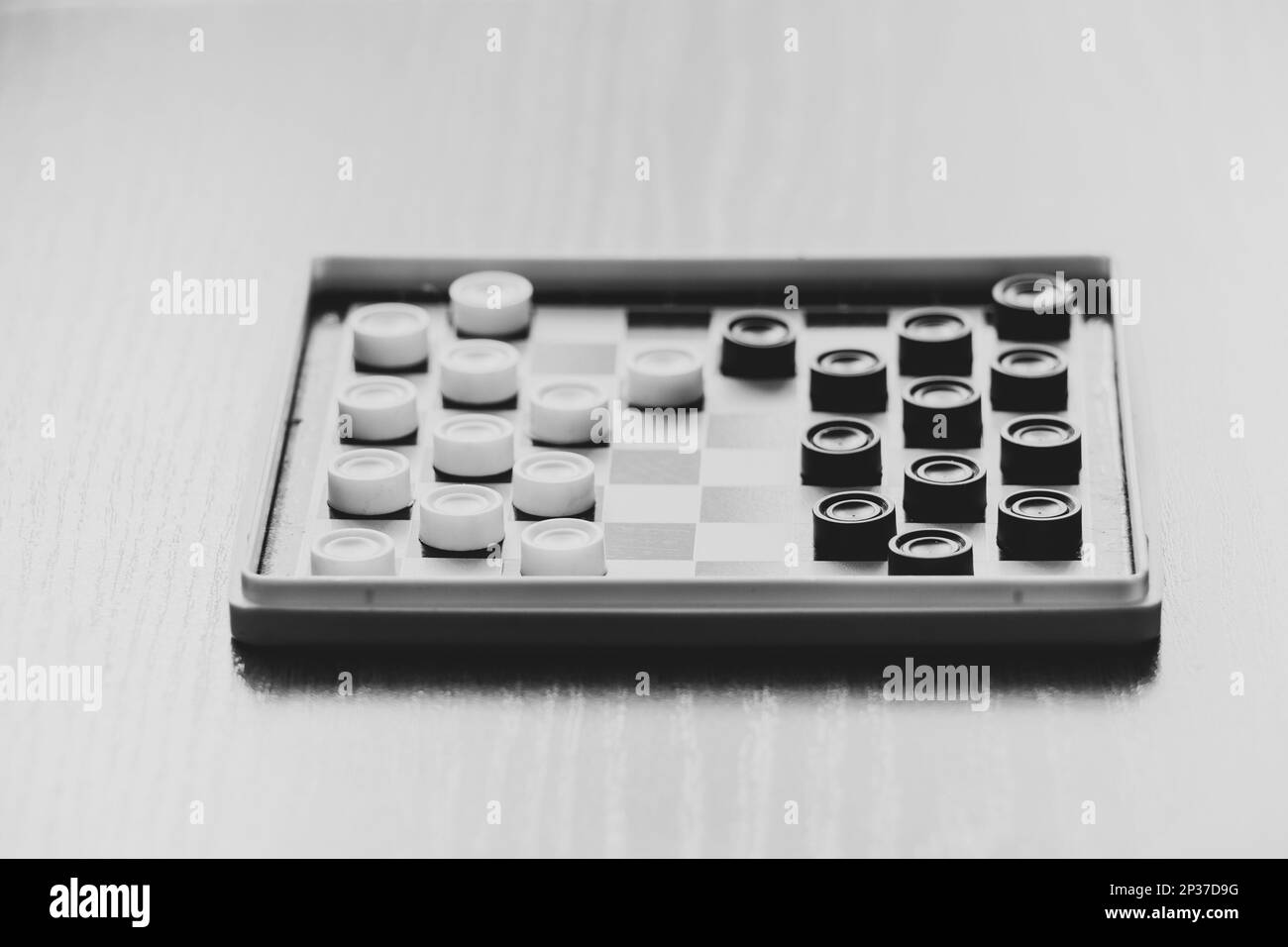 Board small old game checkers on the table, board games, black and