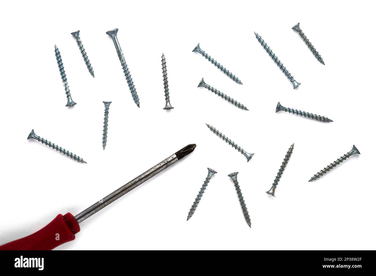 Screwdriver and a group of screws isolated on white background, top view Stock Photo