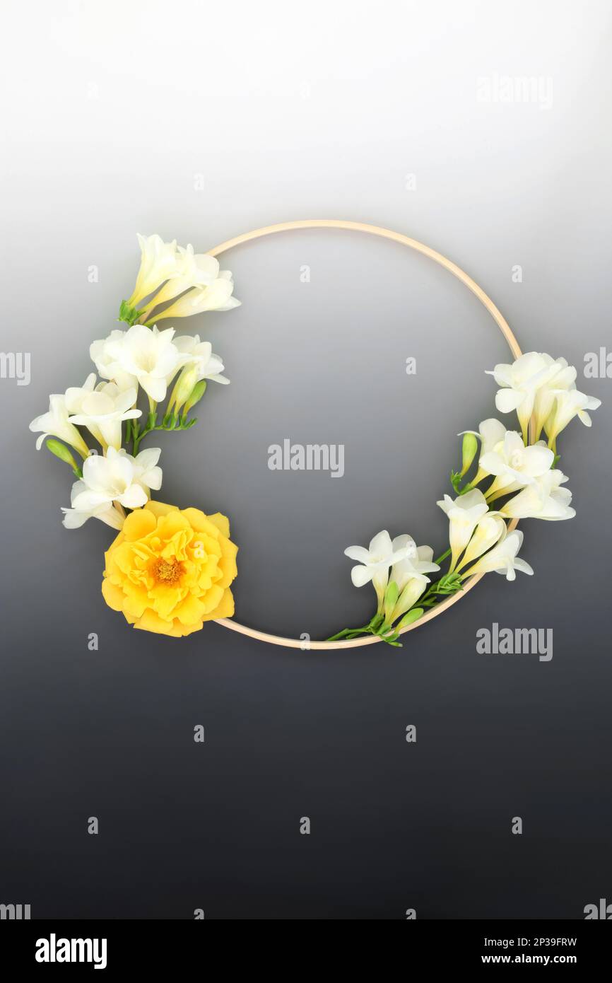 Floral wreath for in memorium sympathy card with freesia and rose flower and wooden frame. Minimal condolence round shape logo symbol on gradient grey Stock Photo