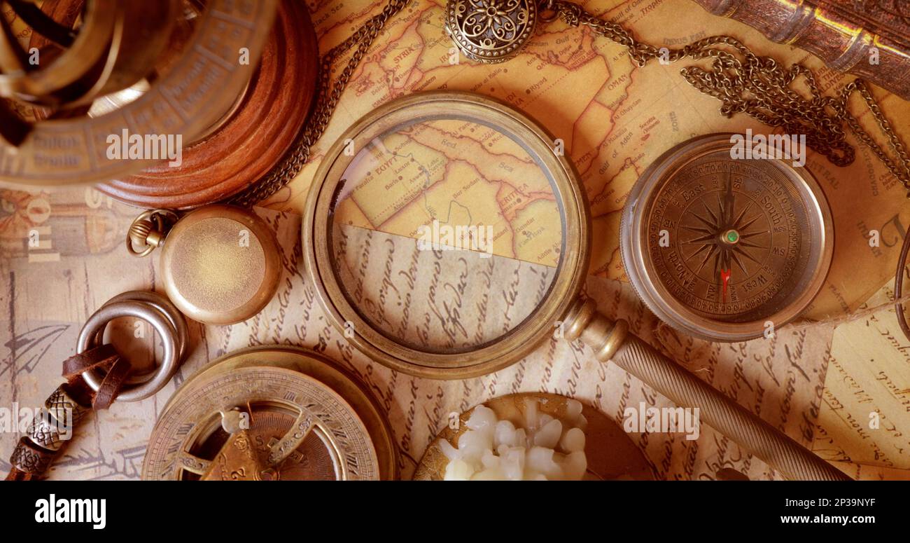 Vintage style travel and adventure. Vintage old compass and other vintage items on the table. Stock Photo