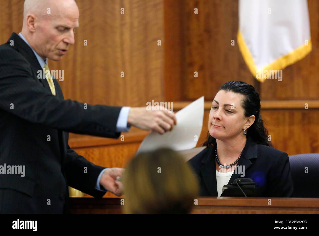 Assistant district attorney William McCauley, left, questions witness