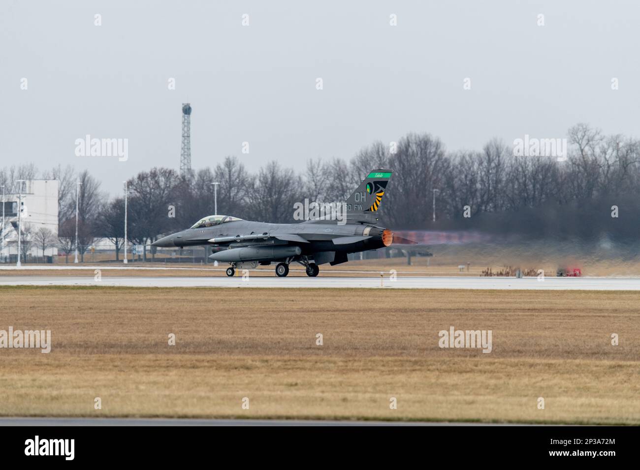 A U.S. Air Force F-16 Fighting Falcon, assigned to the Ohio National Guard’s 180th Fighter Wing, takes off for a training flight at the 180FW in Swanton, Ohio, Jan. 8, 2023. The 180FW is the only F-16 fighter wing in the State of Ohio, whose mission is to provide for America; protection of the homeland, effective combat power and defense to civil authorities, while developing Airmen, supporting their families and serving in the community. Stock Photo